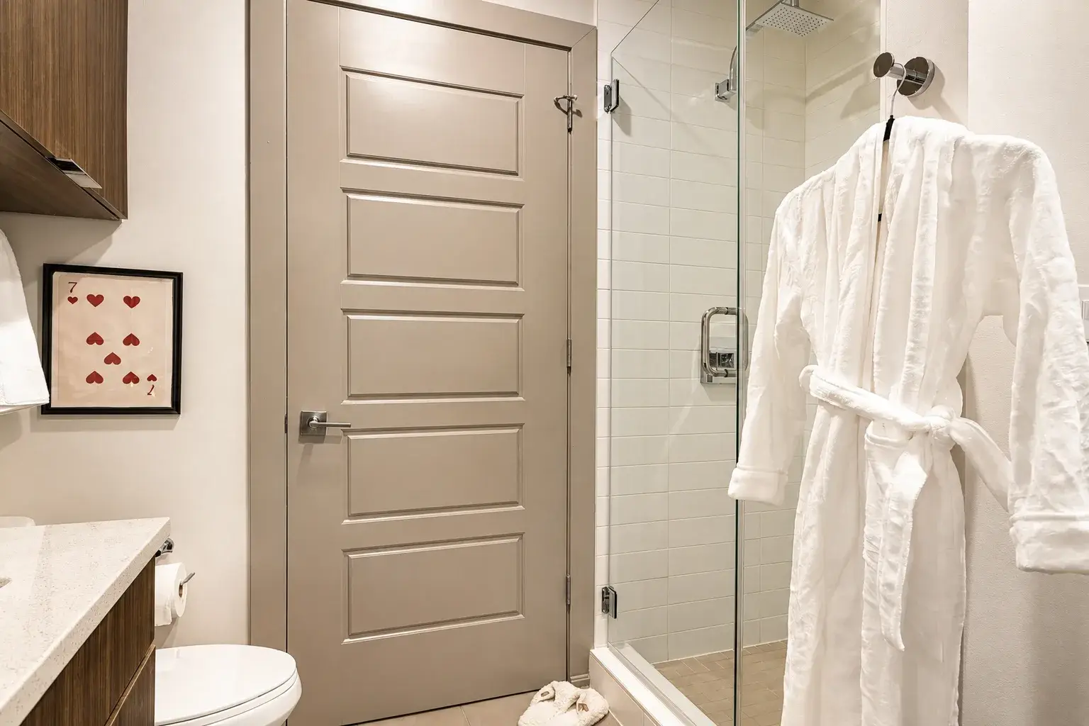Spa-inspired bathroom with glass shower and plush robes