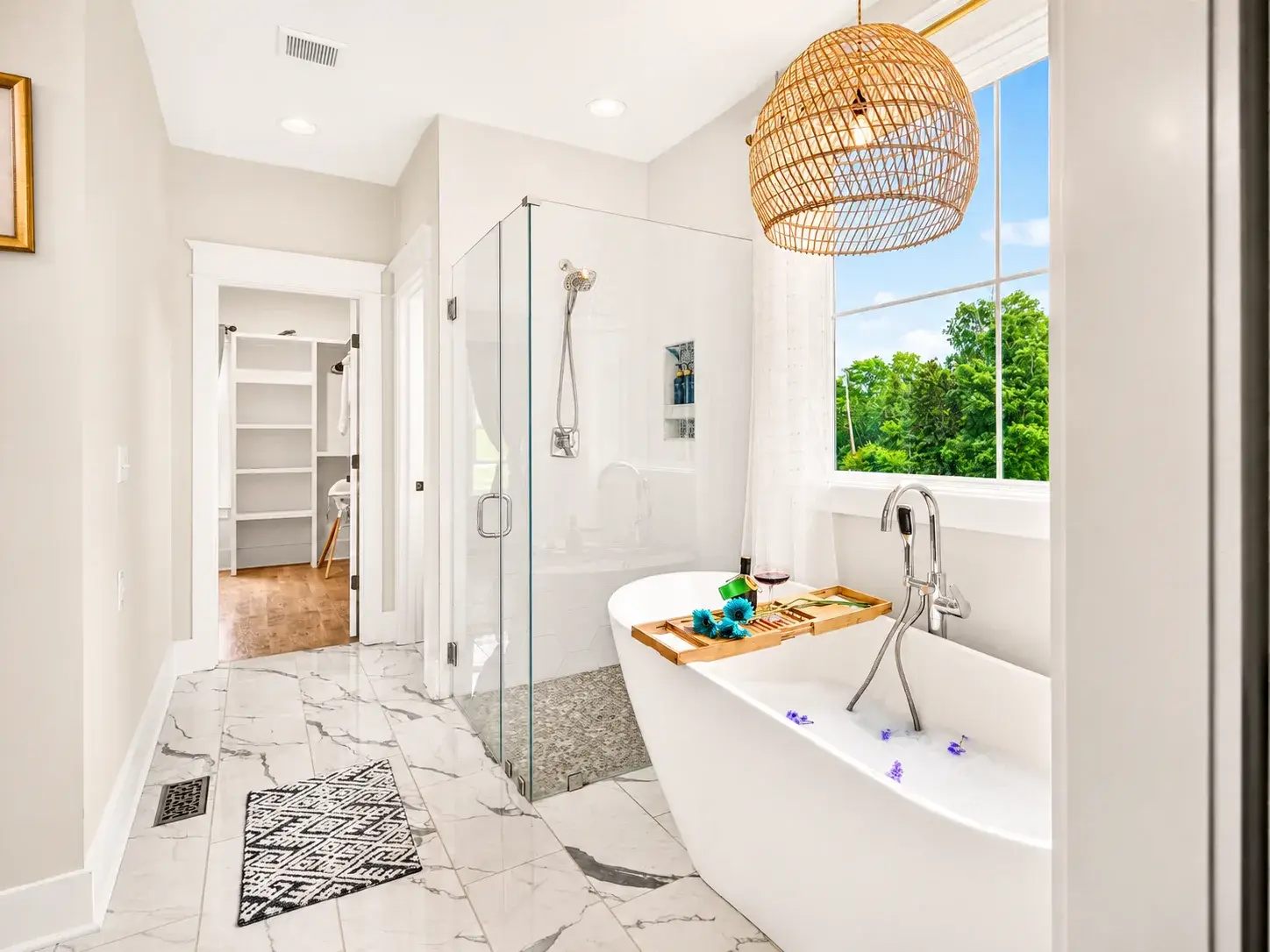 Spa-inspired bath with soaking tub, walk-in shower, and sunny window views
