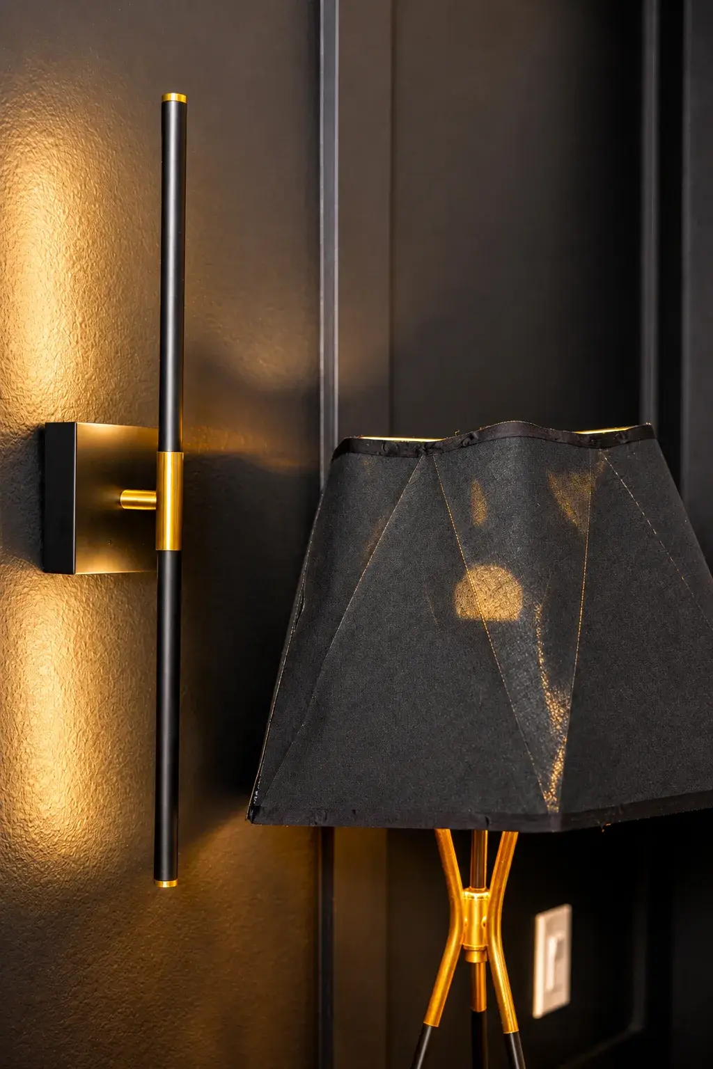 Elegant black-and-brass lighting with warm, upscale ambiance