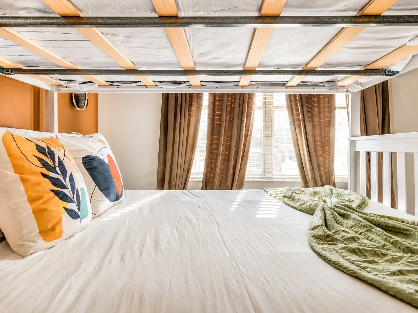 Bright and cozy bunk bed nook with soft bedding and natural light