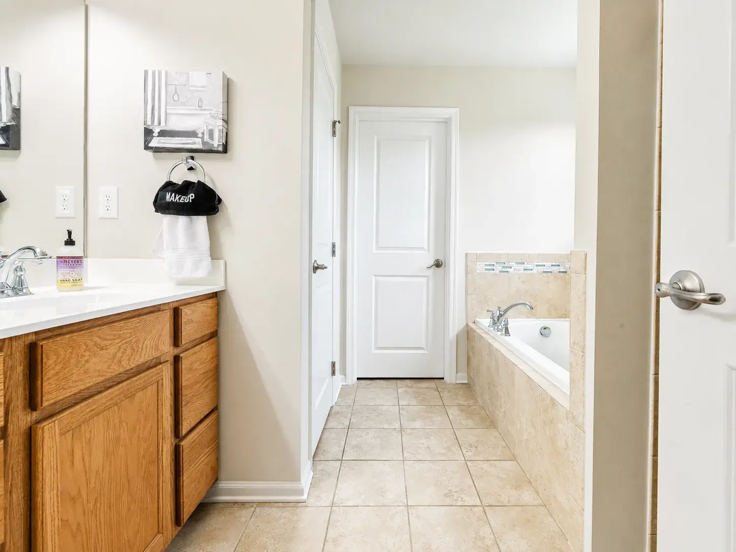 Bright bathroom with roomy vanity and relaxing soaking tub