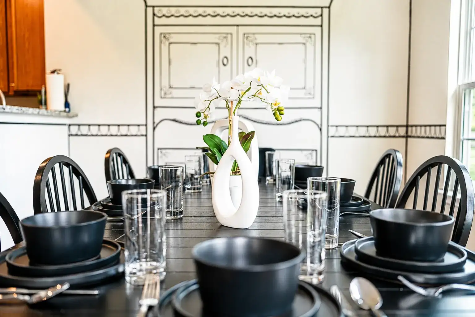 Elegant group dining space with modern table setting and bright natural light