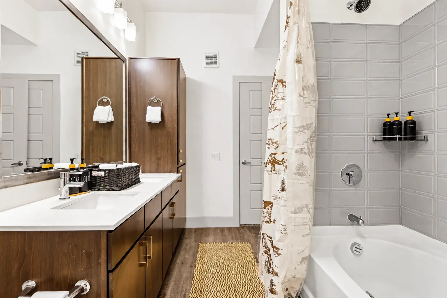 Bright modern bathroom with spacious vanity and stylish tiled tub-shower