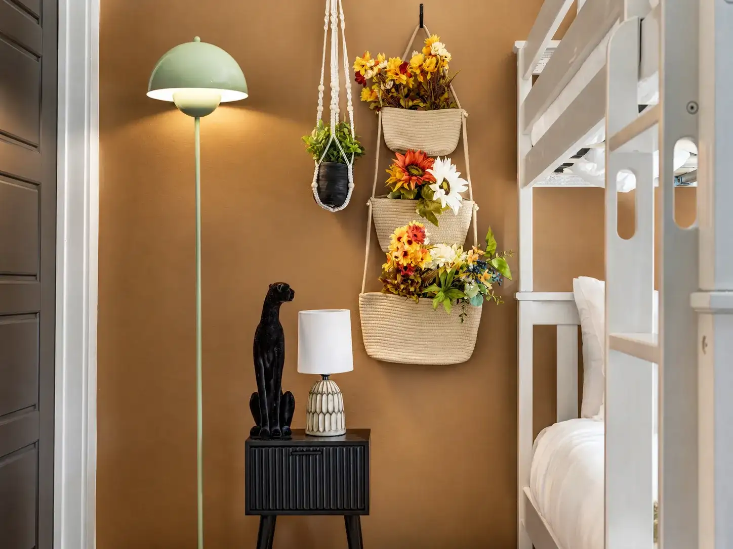 Cozy bunk nook with warm lighting and charming floral wall accents