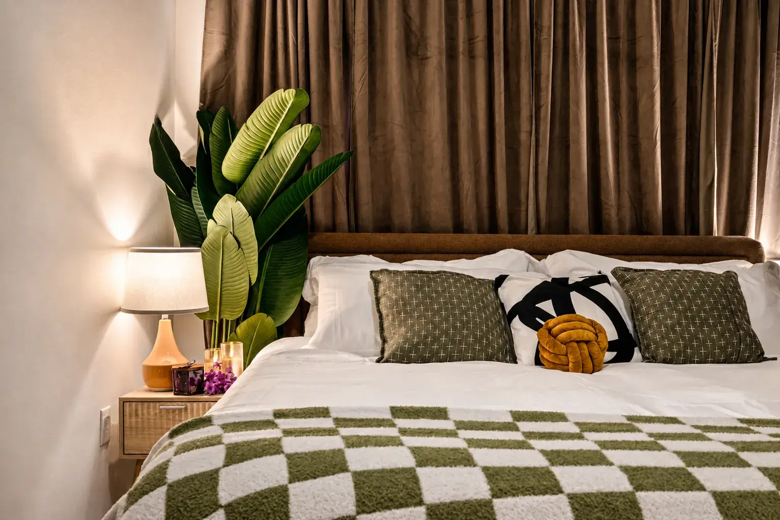 Cozy designer bedroom with plush linens, warm lighting, and chic decor