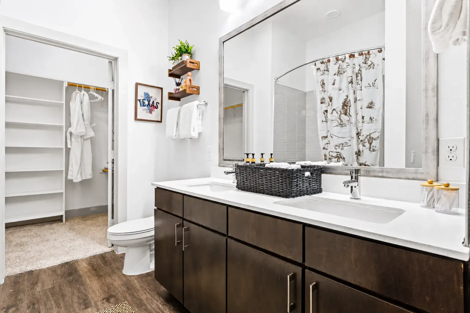 Bright double-vanity bathroom with walk-in closet and thoughtful guest touches