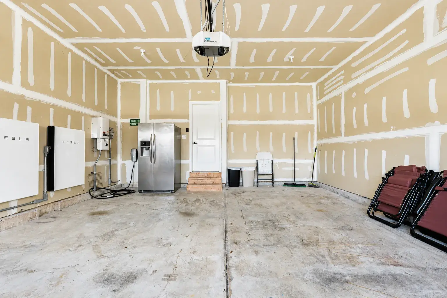 Spacious garage with EV charging, Tesla Powerwalls, and extra storage